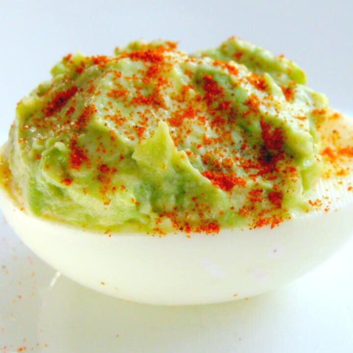 avocado stuffed egg with paprika on top
