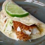 fish taco with slice of lime on top