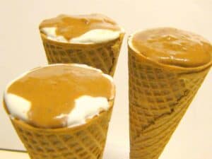 ice cream cone filled with topping and peanut butter