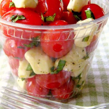 Picnic Tomato Caprese salad in clear cup with fork