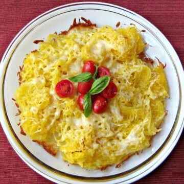 spaghetti squash and cheese on plate with cherry tomatoes