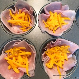 muffin tin with ham and cheese