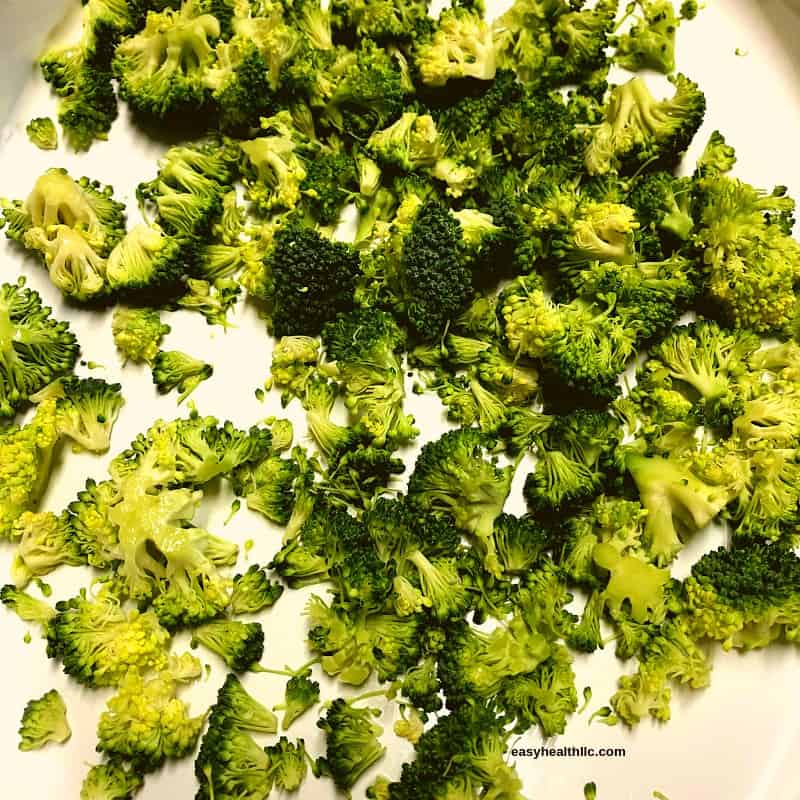 broccoli florets in white casserole dish ready for microwave