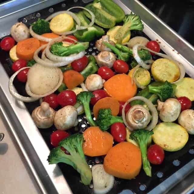Veggies on grate ready to be grilled.