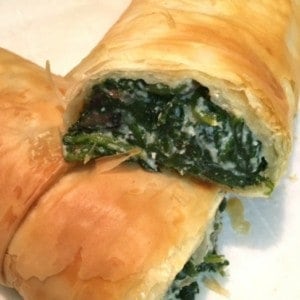 spinach ricotta roll on white plate
