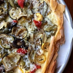 Phyllo Pizza with Roasted Veggies and Ricotta on white plate