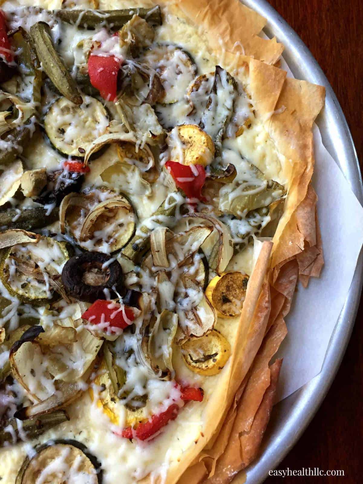 Phyllo Pizza with Roasted Veggies and Ricotta on white plate