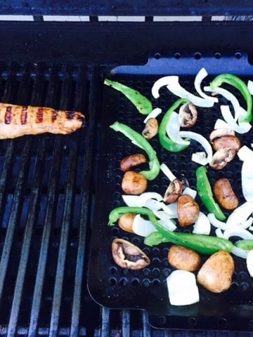 pork tenderloin on grill and grill rack with peppers, onions and mushrooms