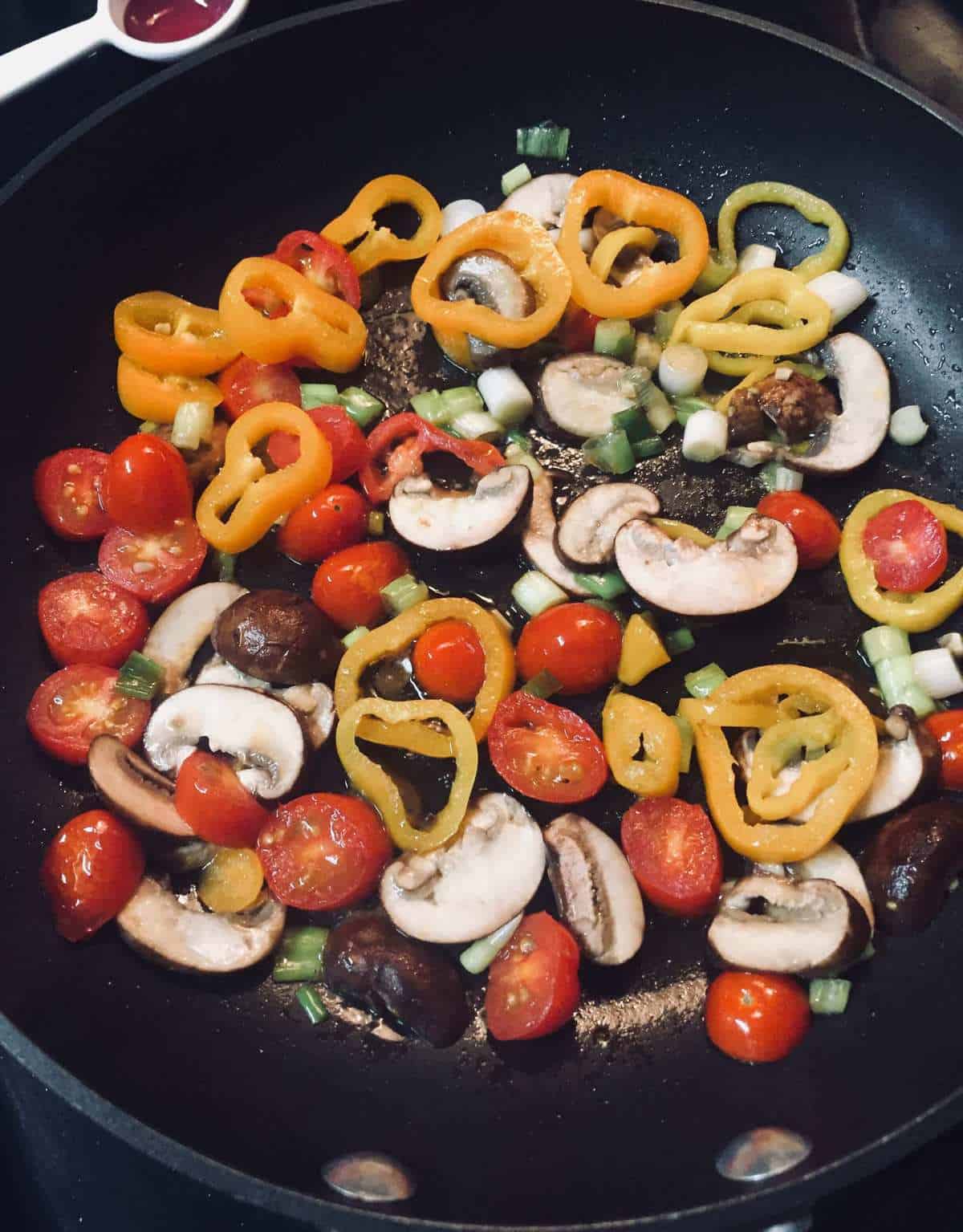 skillet with cherry tomatoes, mushrooms, yellow sliced peppers