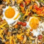 breakfast hash with 2 eggs in iron skillet