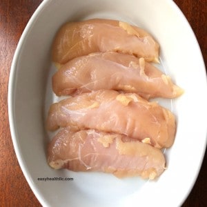 raw chicken tenders in white bowl