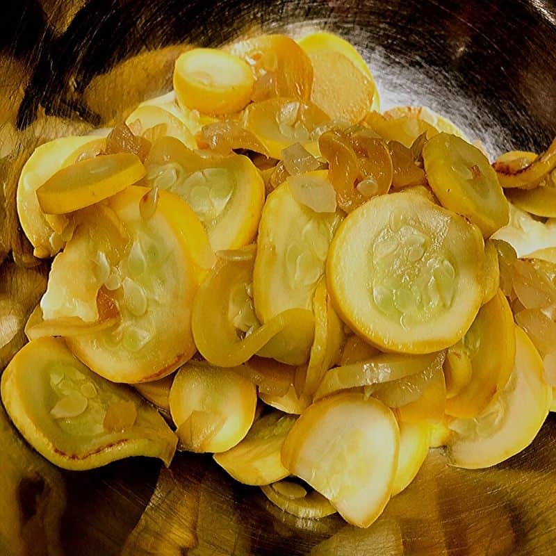 sautéed sliced yellow squash and onions in mixing bowl