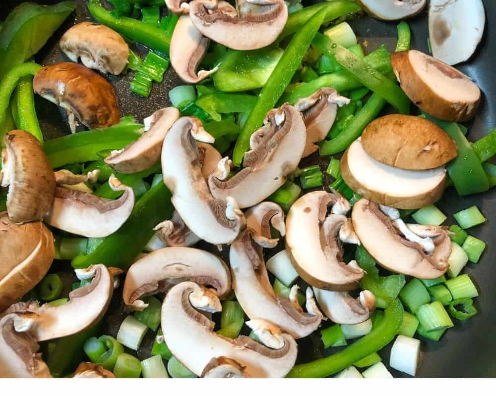 peppers and mushrooms in skillet
