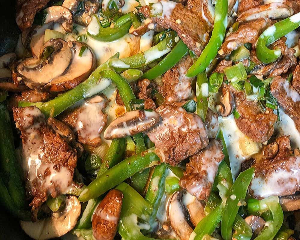 steak, peppers and mushrooms in bowl