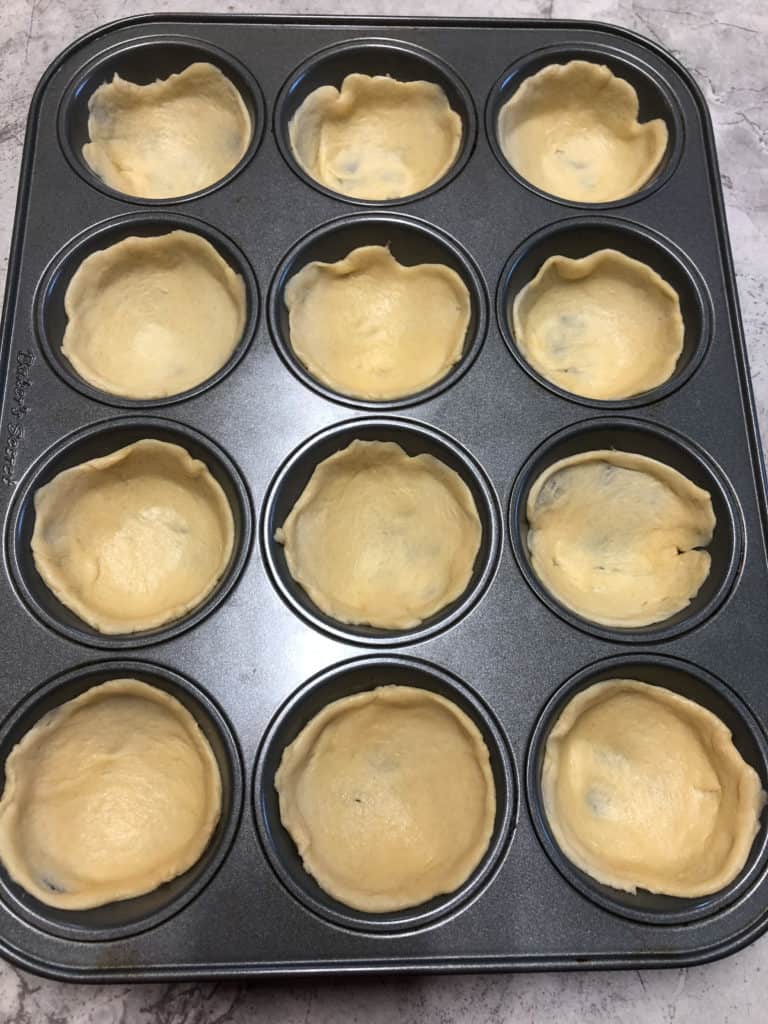 crescent roll dough in muffin tin
