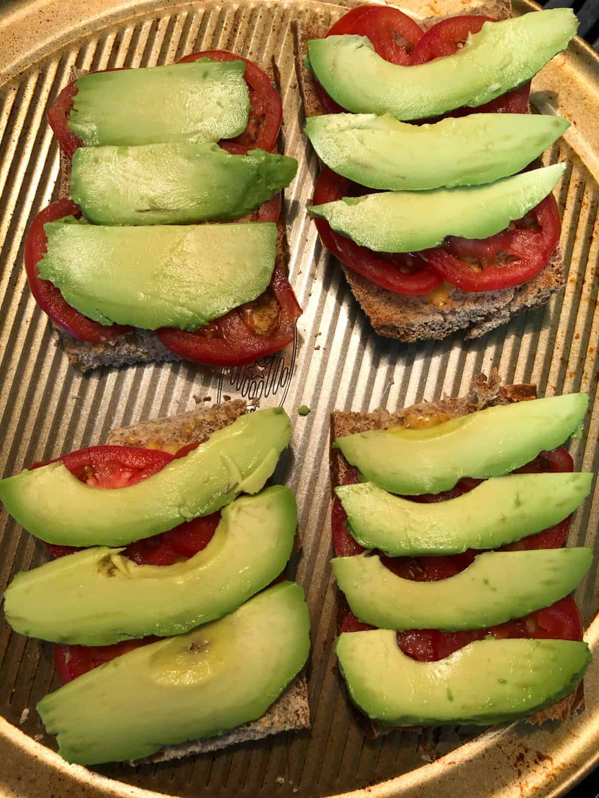 sliced avocado and tomatoes on toast