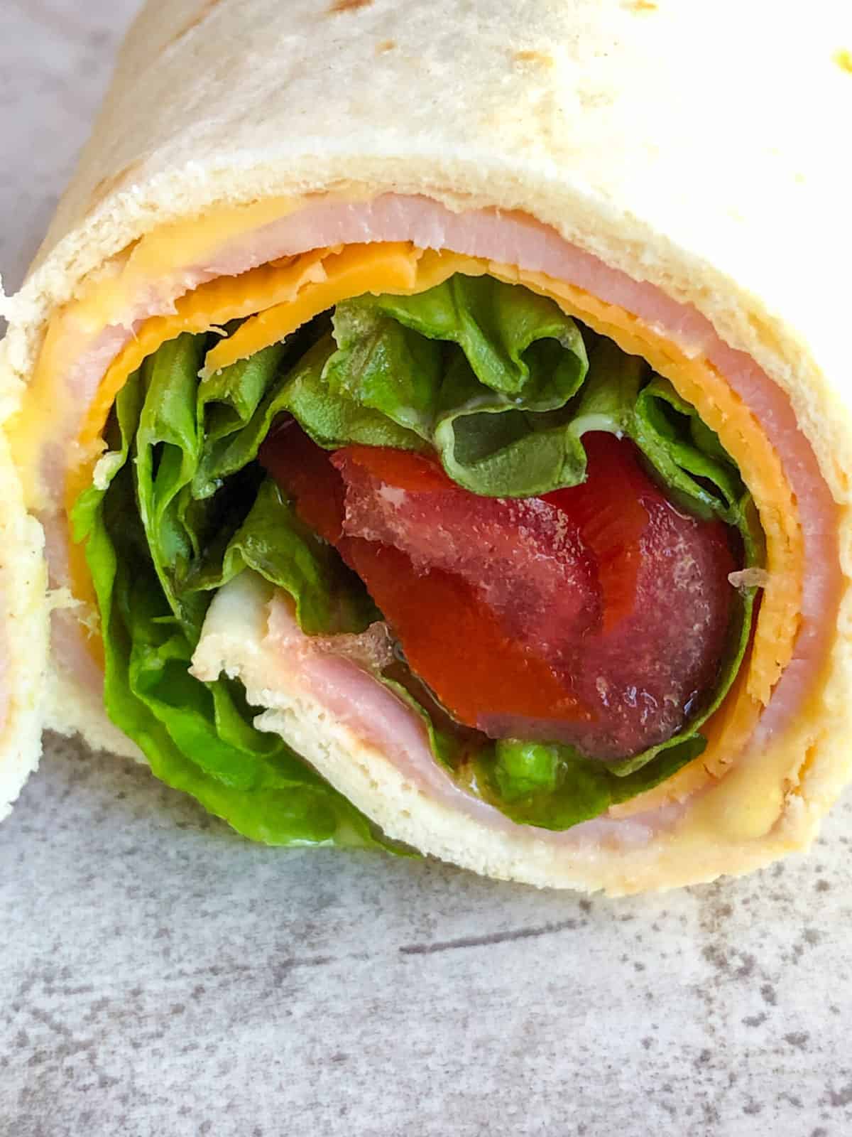 turkey roll up on cutting board