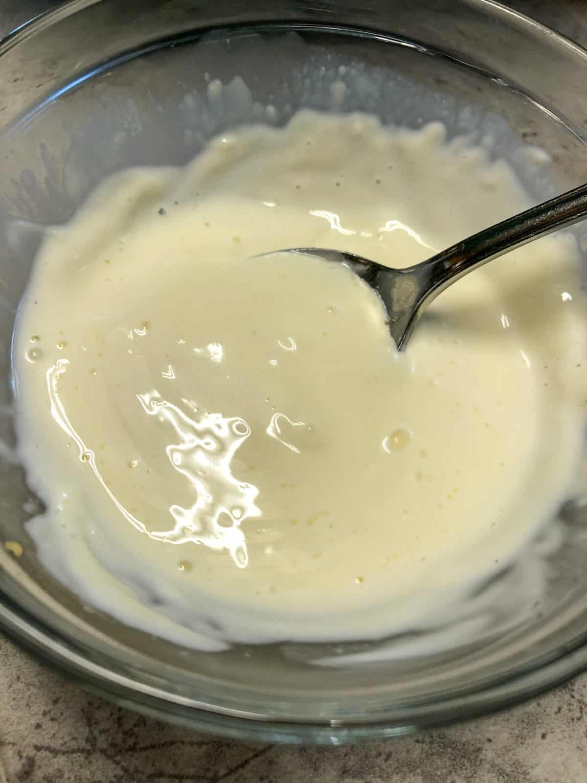 dressing for broccoli salad in clear bowl
