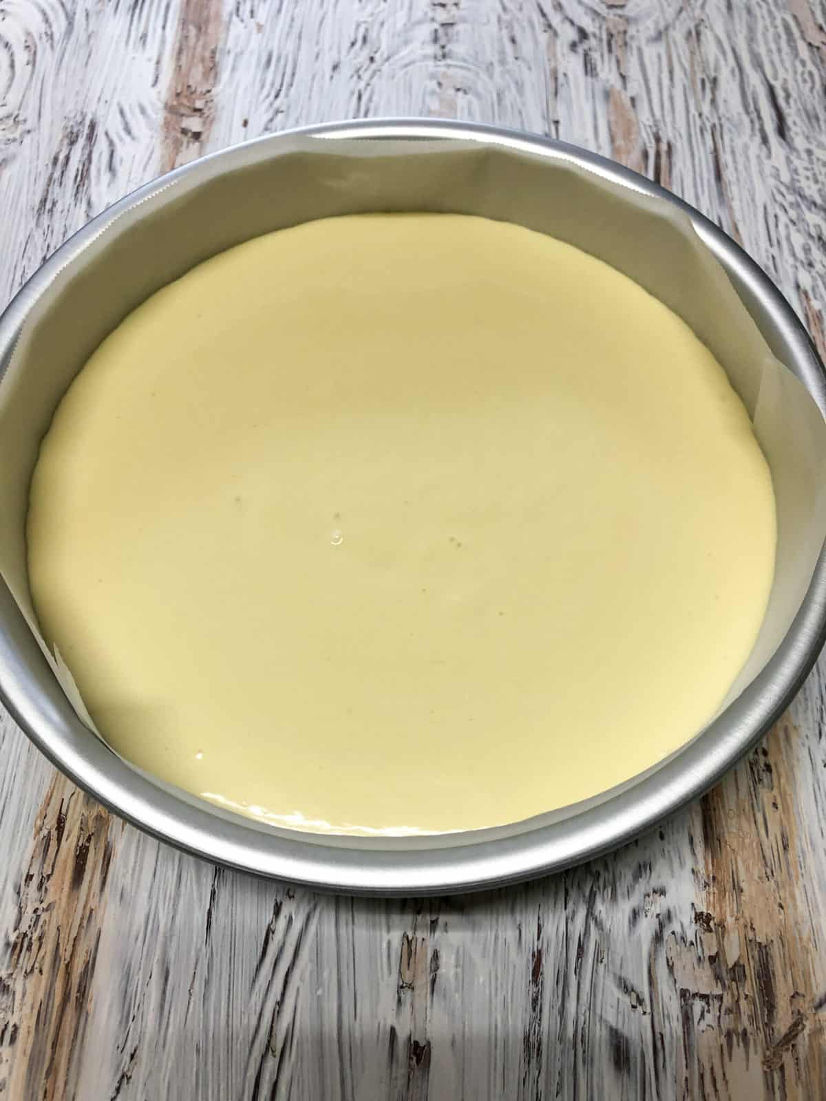 cheesecake batter in pan ready for oven