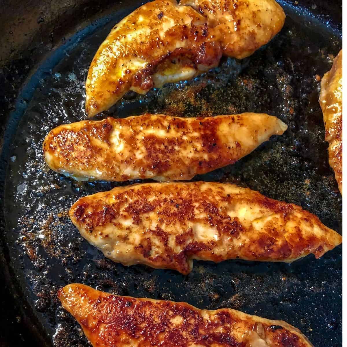 cooked chicken tenders in skillet