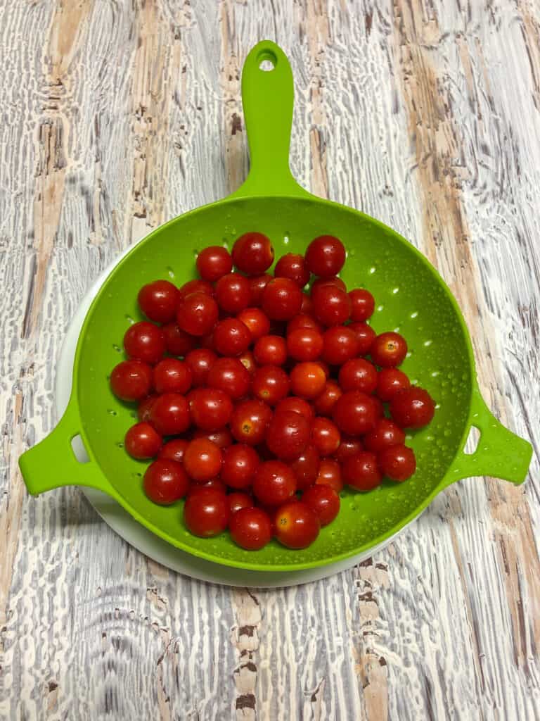 cherry tomatoes in green colander