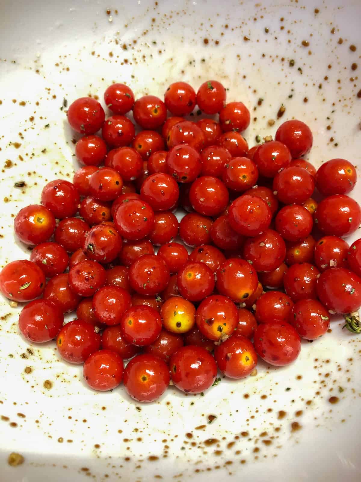 cherry tomatoes in bowl with seasonings