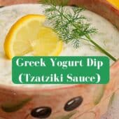 greek yogurt dip in bowl with lemon slice