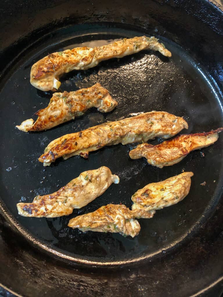 chicken tenders browning in skillet