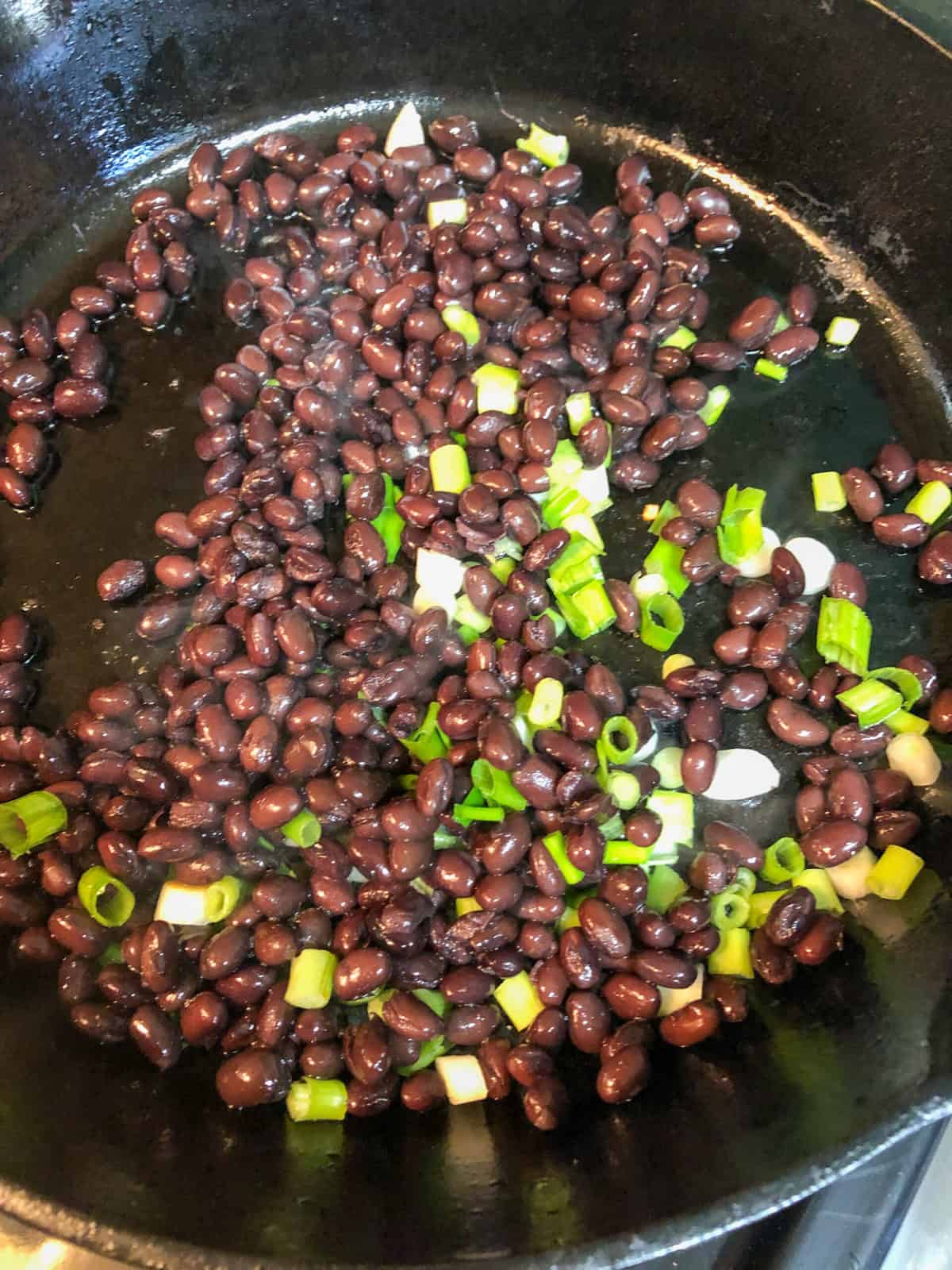 black beans and onions in skillet