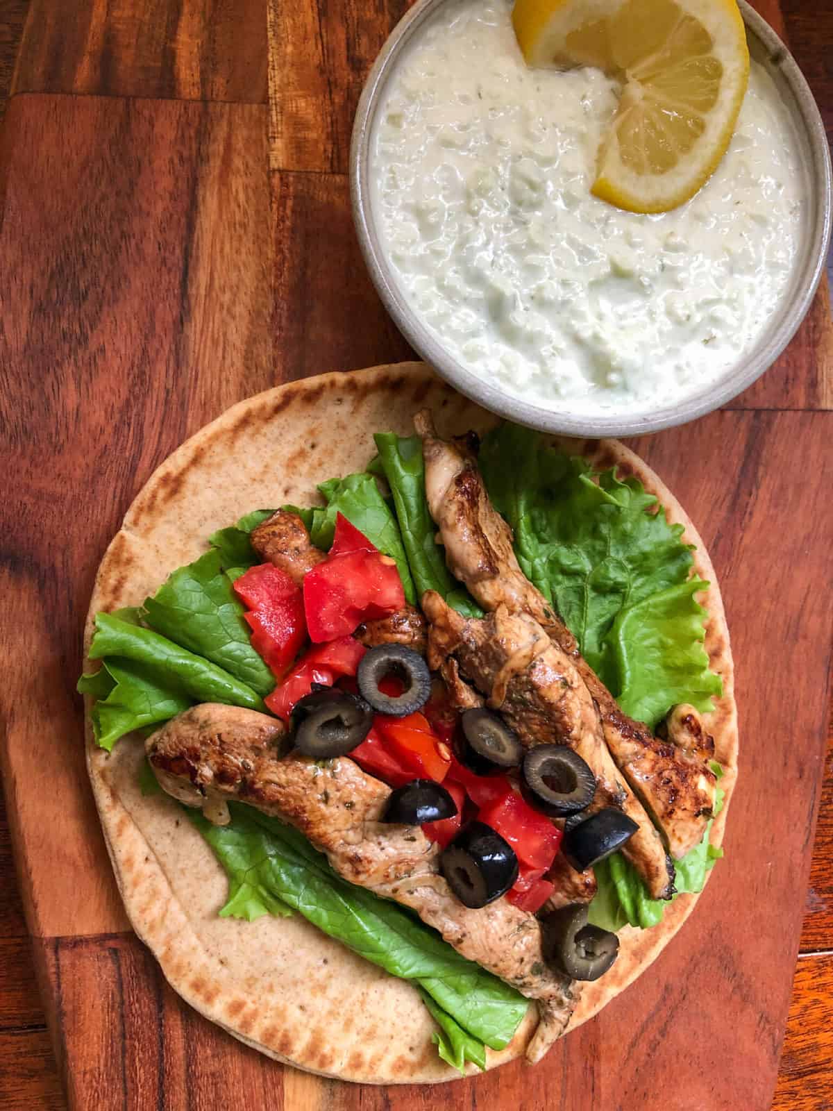 pita bread with chicken on cutting board