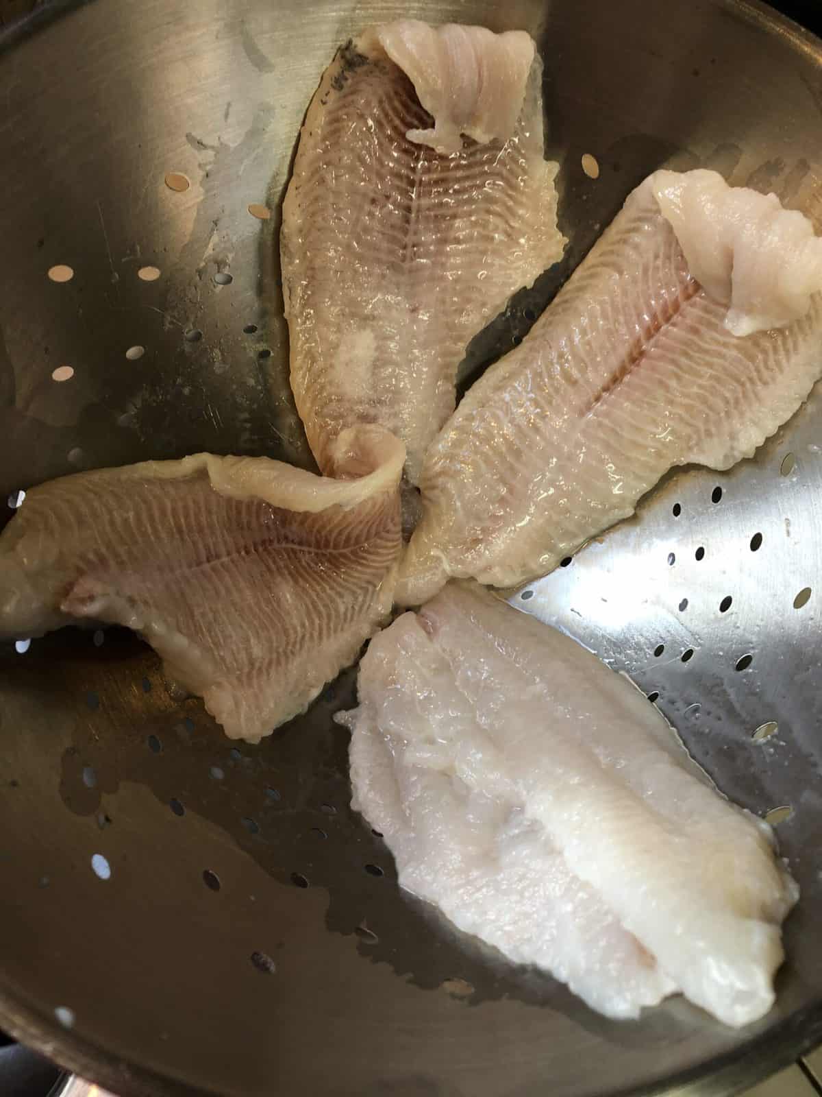 catfish draining in colander