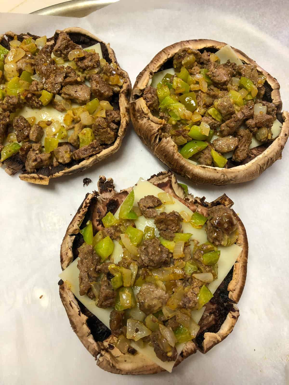 mushroom with slice of cheese and filled with beef/onion/green bell pepper mixture