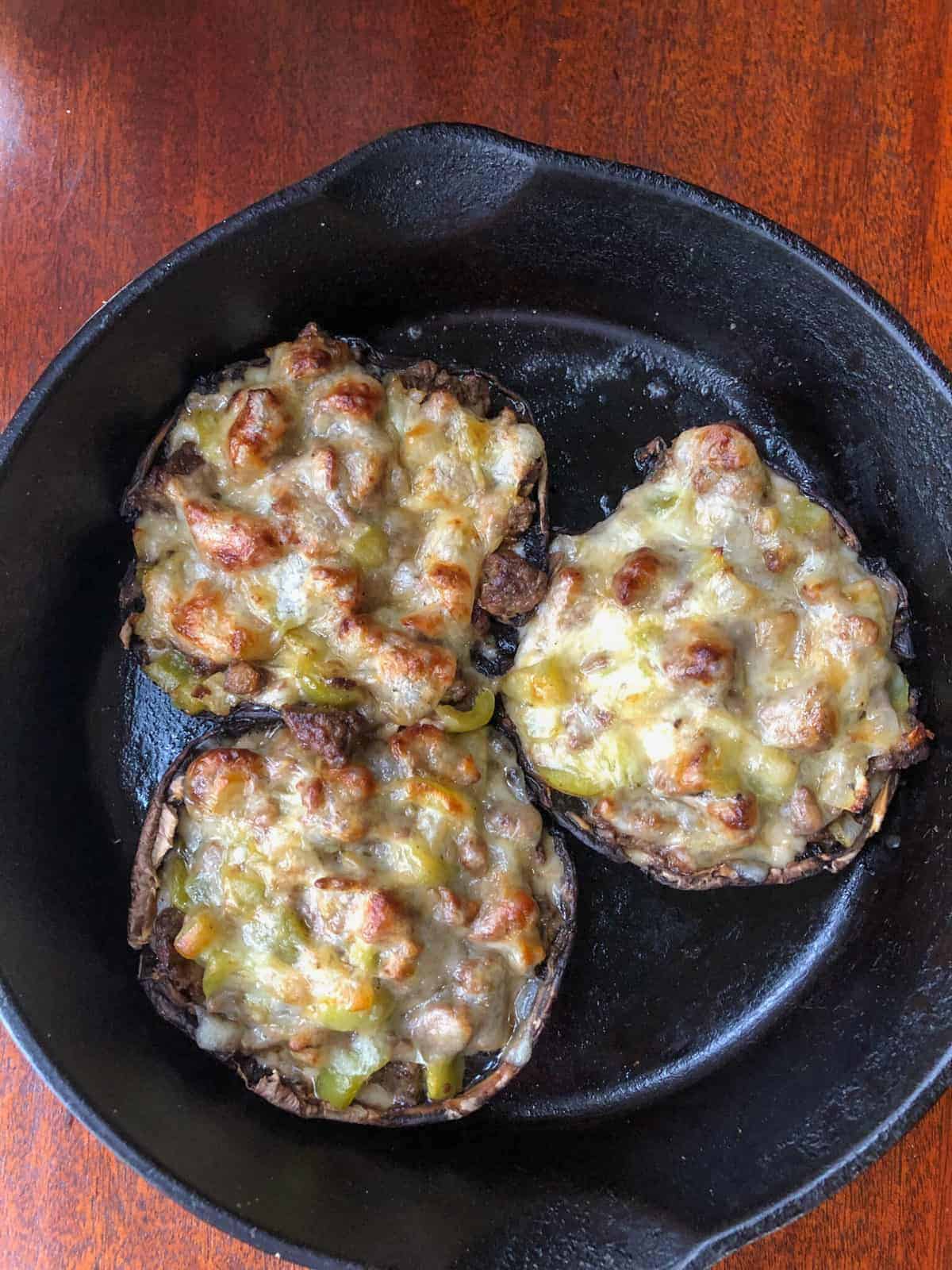 skillet with 3 stuffed mushrooms