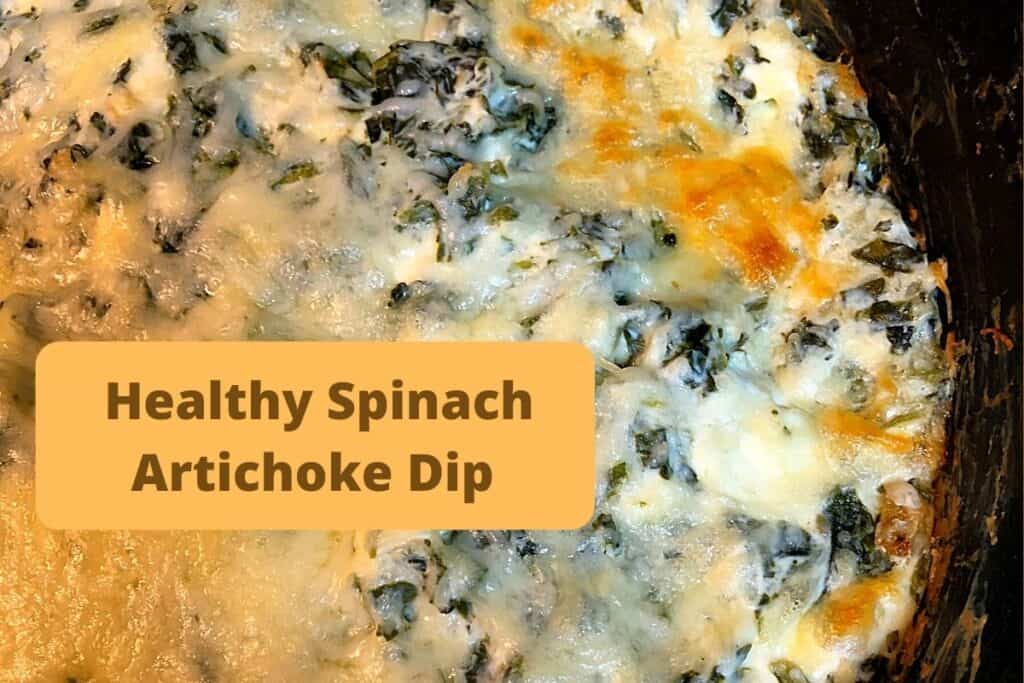 golden brown cheese melted on spinach artichoke dip in black skillet