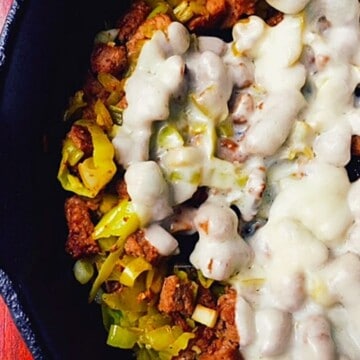 beef and pepperoncini and white cheese in black skillet