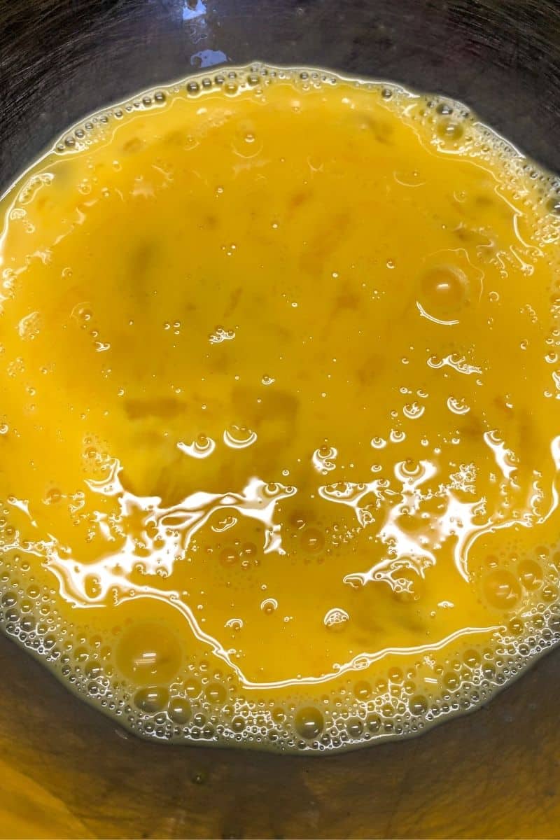 whipped eggs in clear bowl