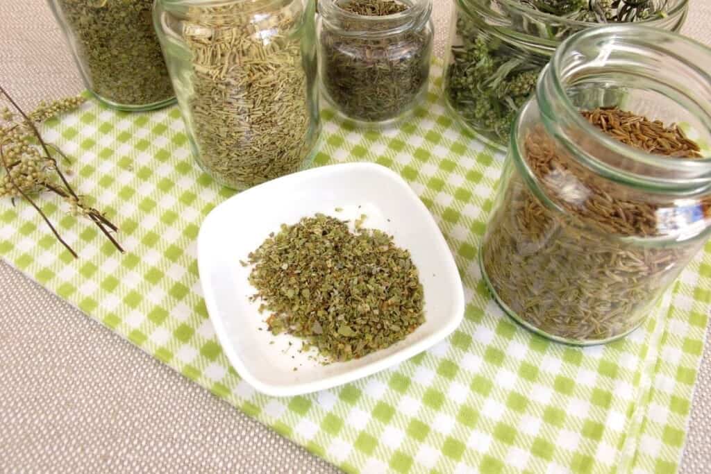 jars of dried herbs on green gingham napkin