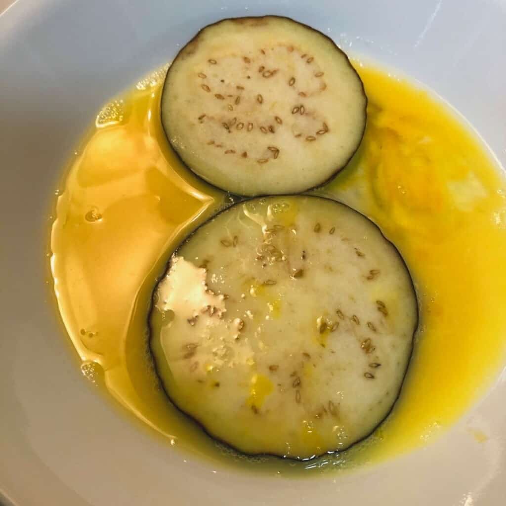 eggplant slices in egg wash