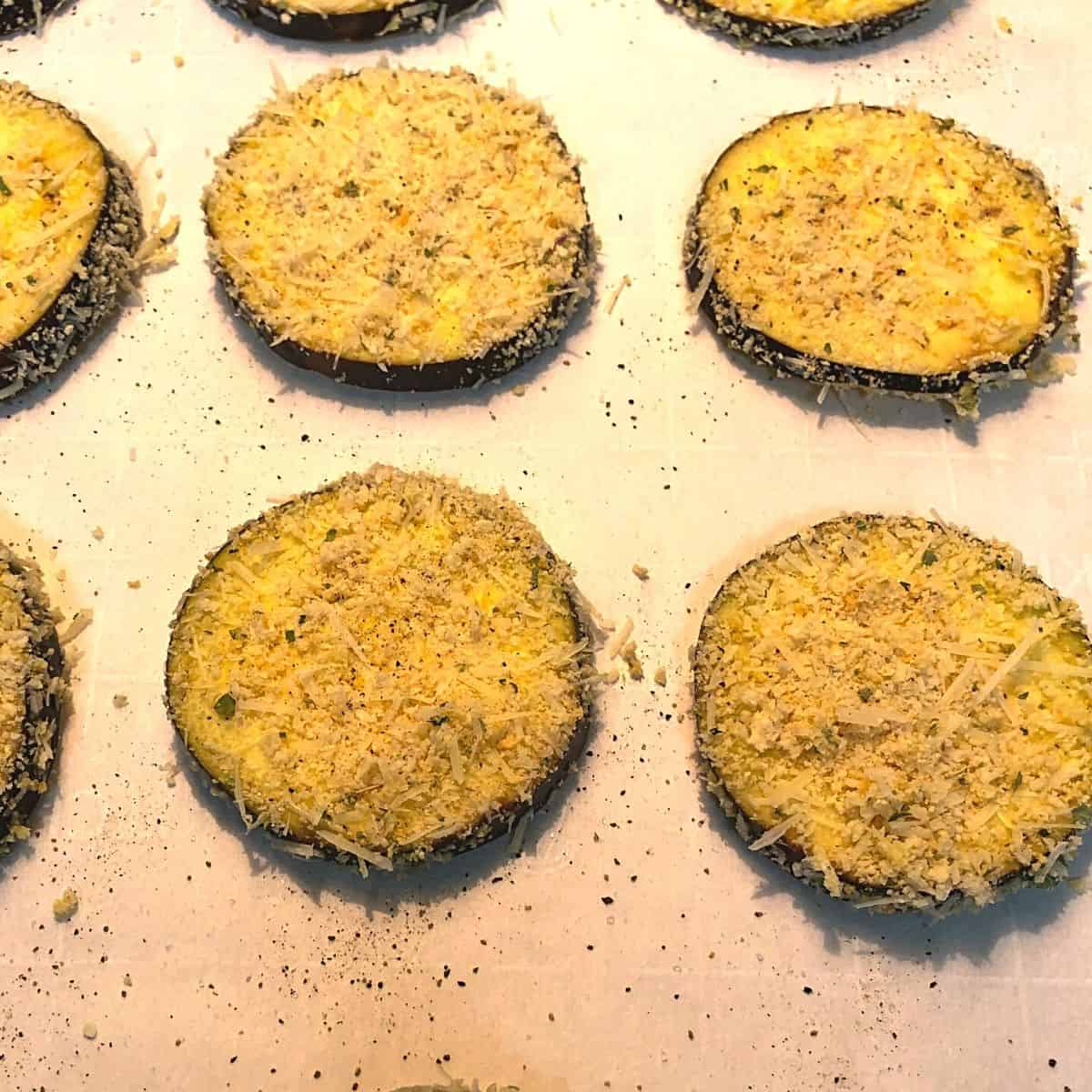breaded eggplant on baking sheet ready for oven