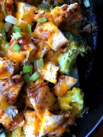 chopped potato with broccoli, chicken, bbq sauce and cheese in black skillet