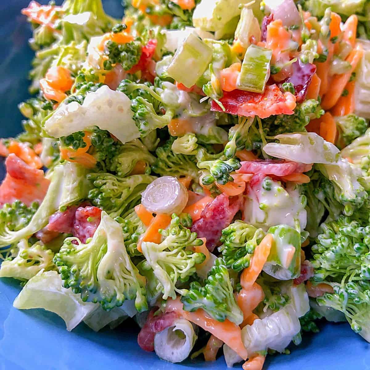 diced broccoli, veggies and cheese in blue bowl