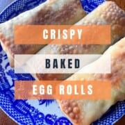 3 baked egg rolls on a blue willow plate with graphic overlay crispy baked egg rolls