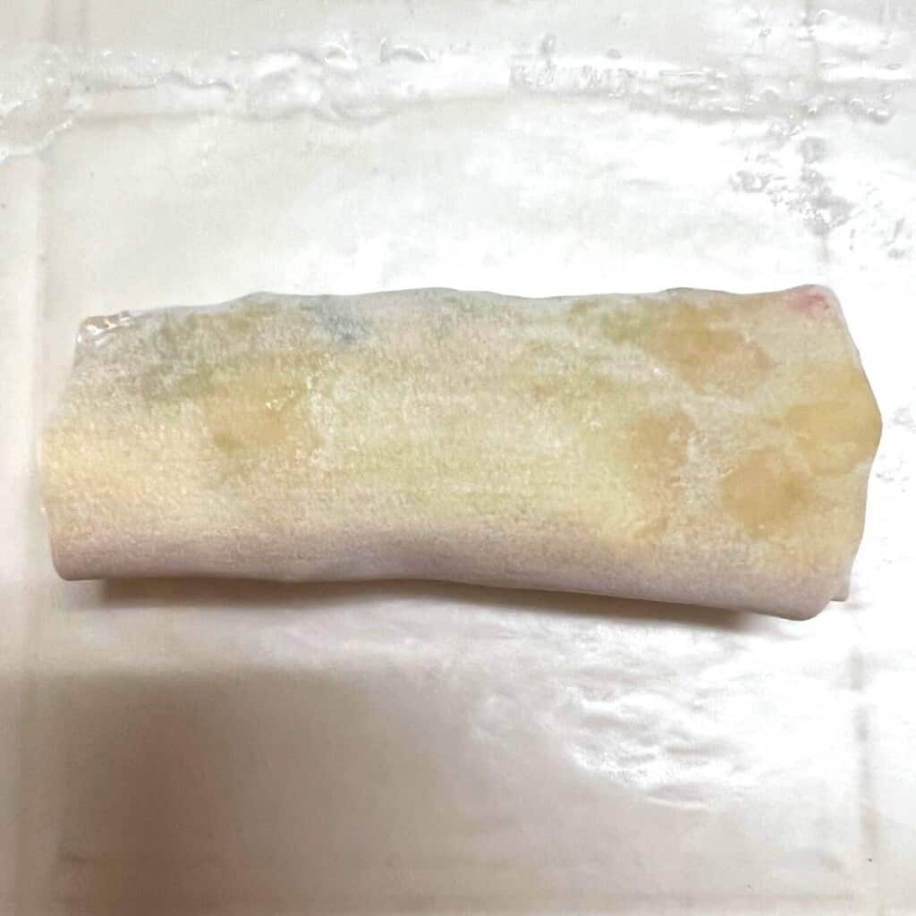 wrapped egg roll on wax paper