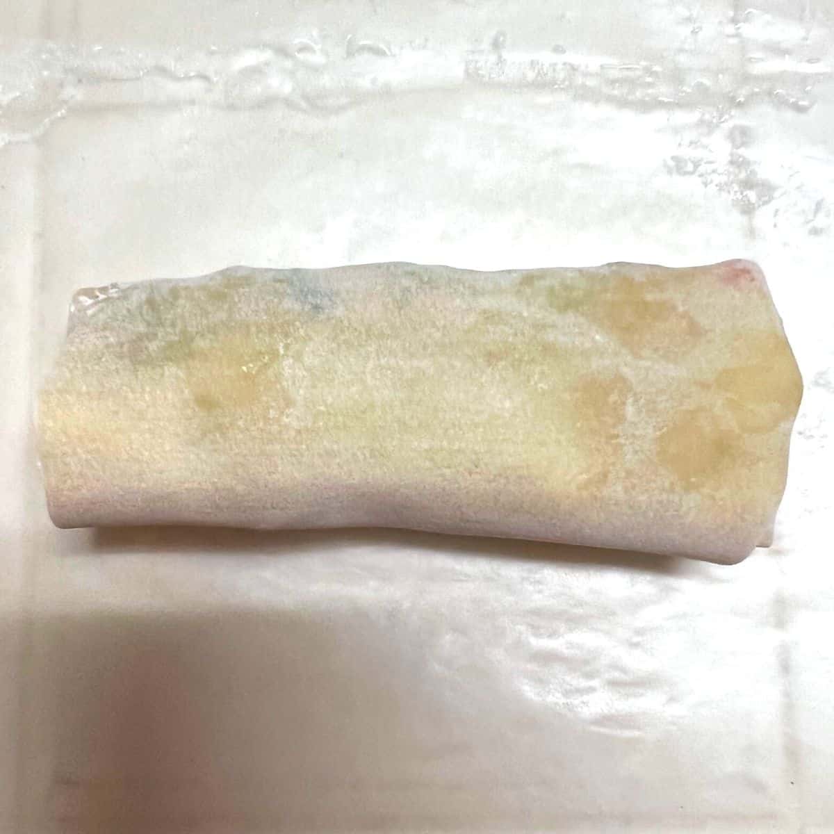wrapped egg roll on wax paper