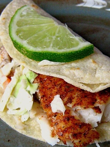 Fish taco close up with lime wedge.