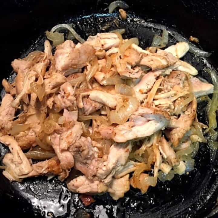 sautéed chicken and onions in iron skillet
