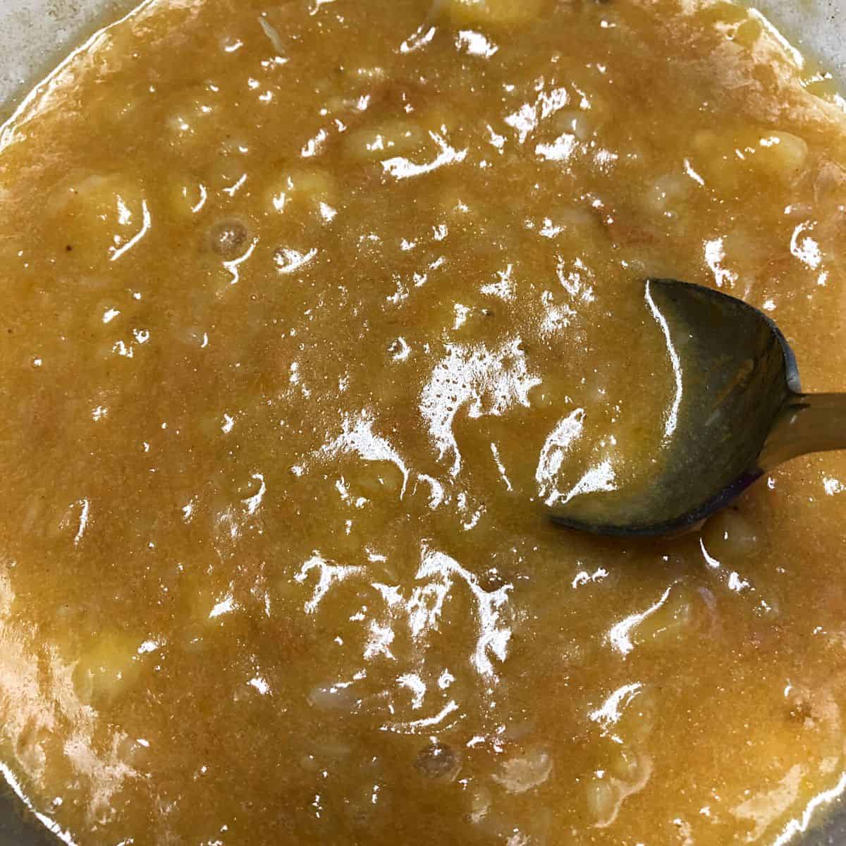 spoon in ingredients for peanut butter banana oat bars