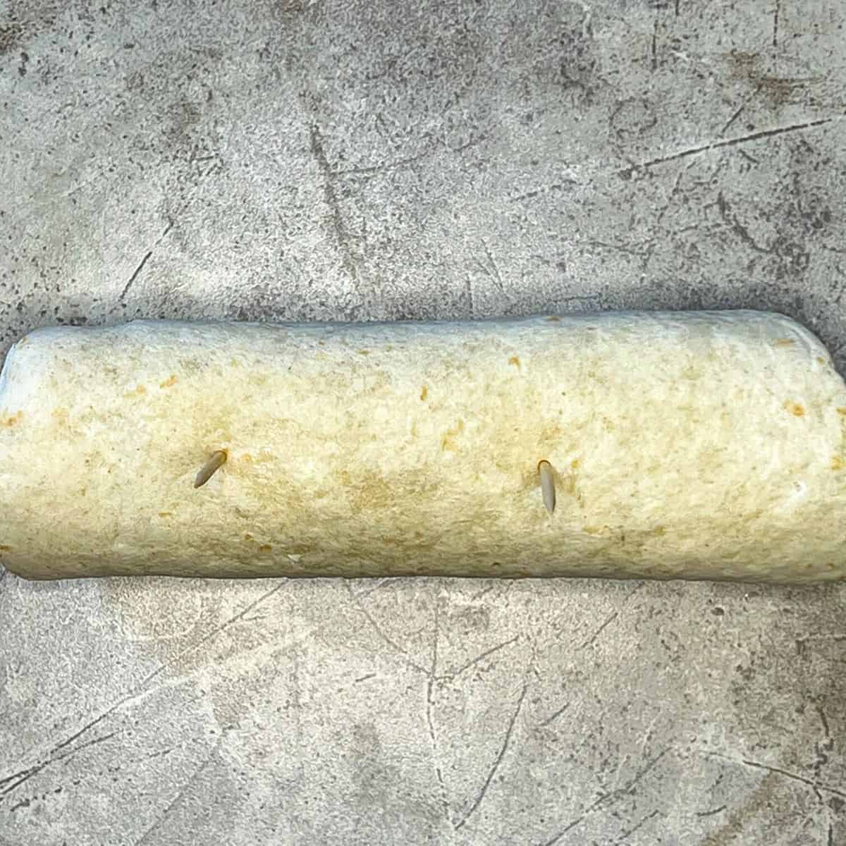 tortilla wrap rolled up and secured with tooth picks
