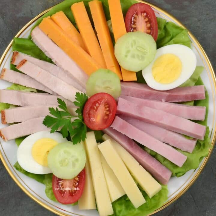 plate with cheese sticks, boiled egg halves, cherry tomatoes