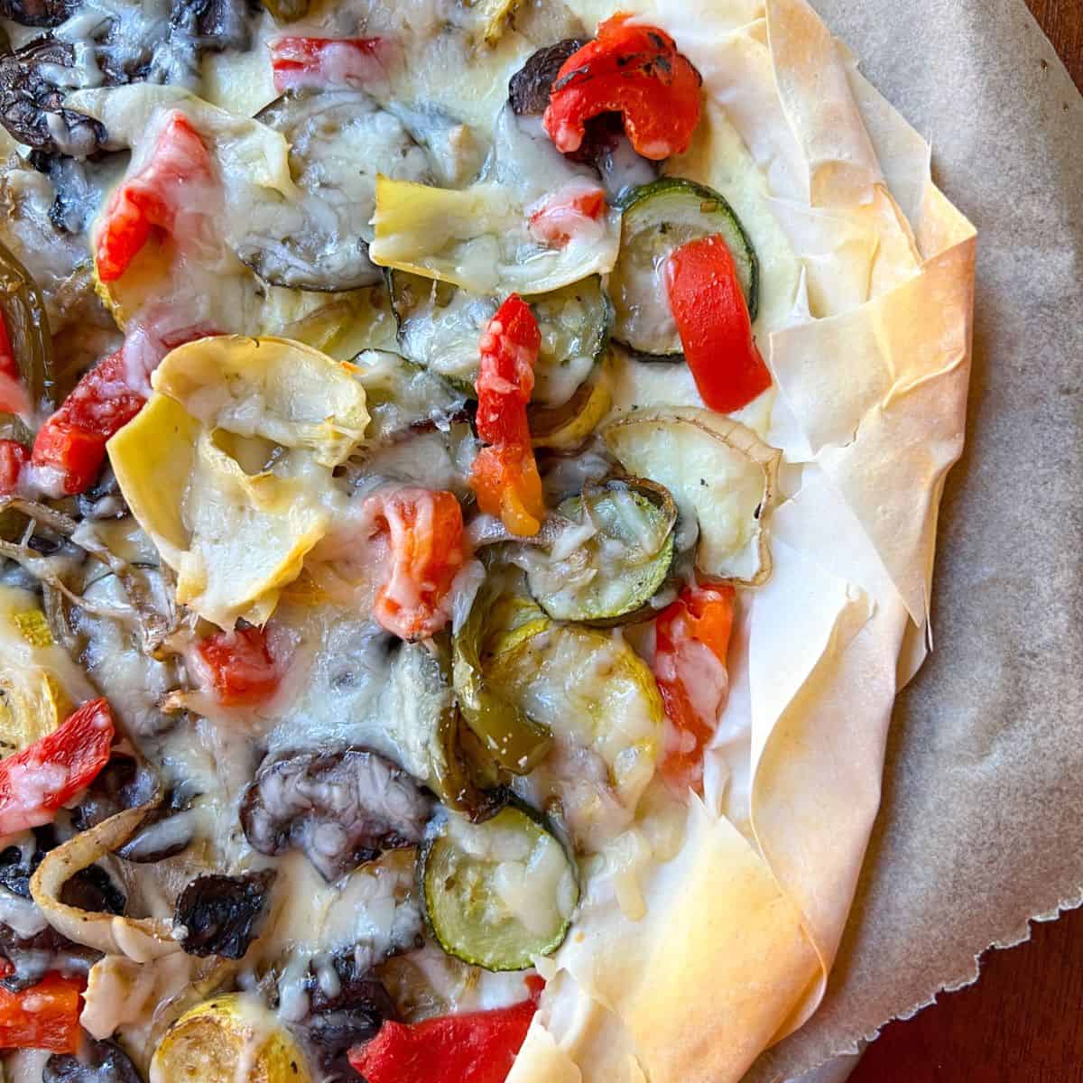 phyllo mediterranean pizza with roasted sliced squash, mushrooms and zucchini